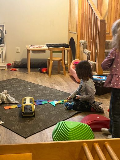 a child creating a pattern with coloured magnets on the floor