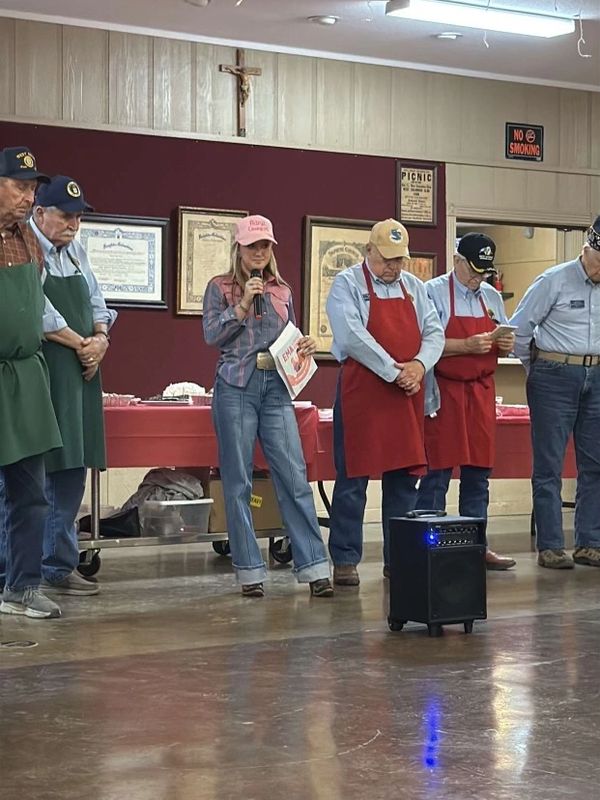 Children’s book Ema the Patriot Cowgirl thanking veterans at VFW hall, surrounded by American flags