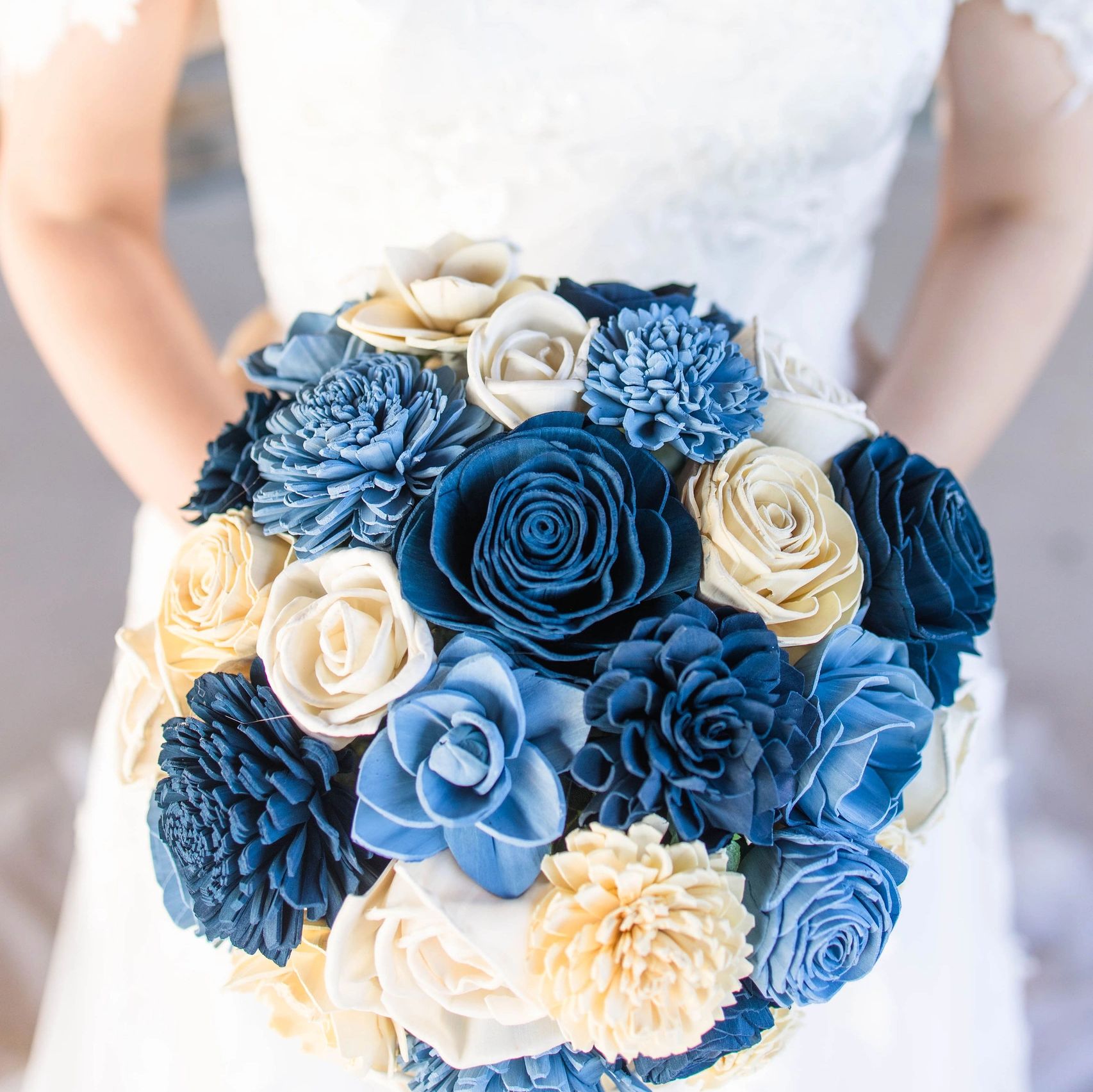 Wood wedding bouquet of flowers in various shades of blue and white.
