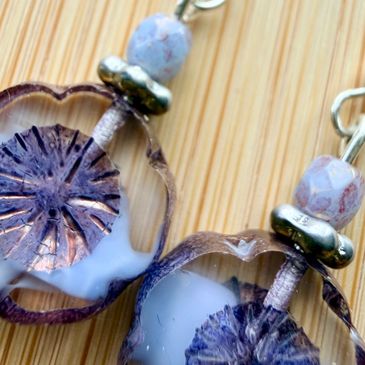 Close-up of unique handmade earrings with translucent floral design.