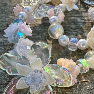 Close-up of a delicate floral and pearl necklace.
