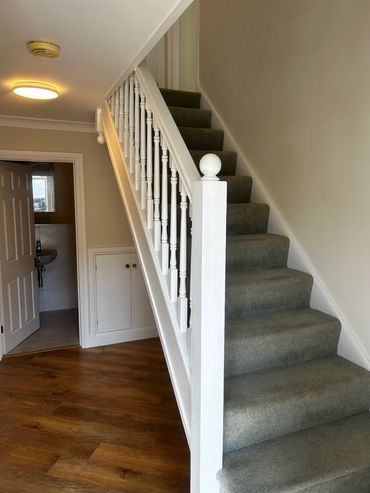 Carpeted staircase in a home hallway.
