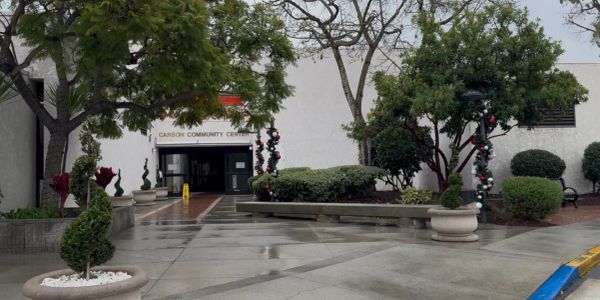 Entrance to the Carson Community Center decorated for the holidays on a wet day.