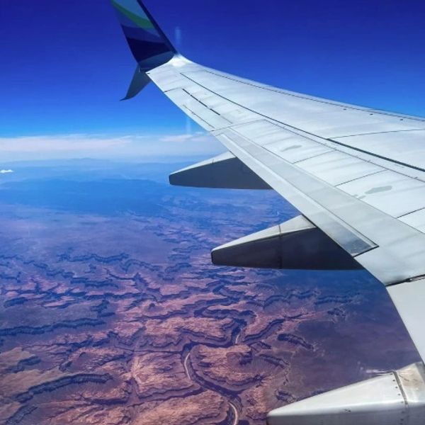 View of a rocky canyon landscape from an airplane window.