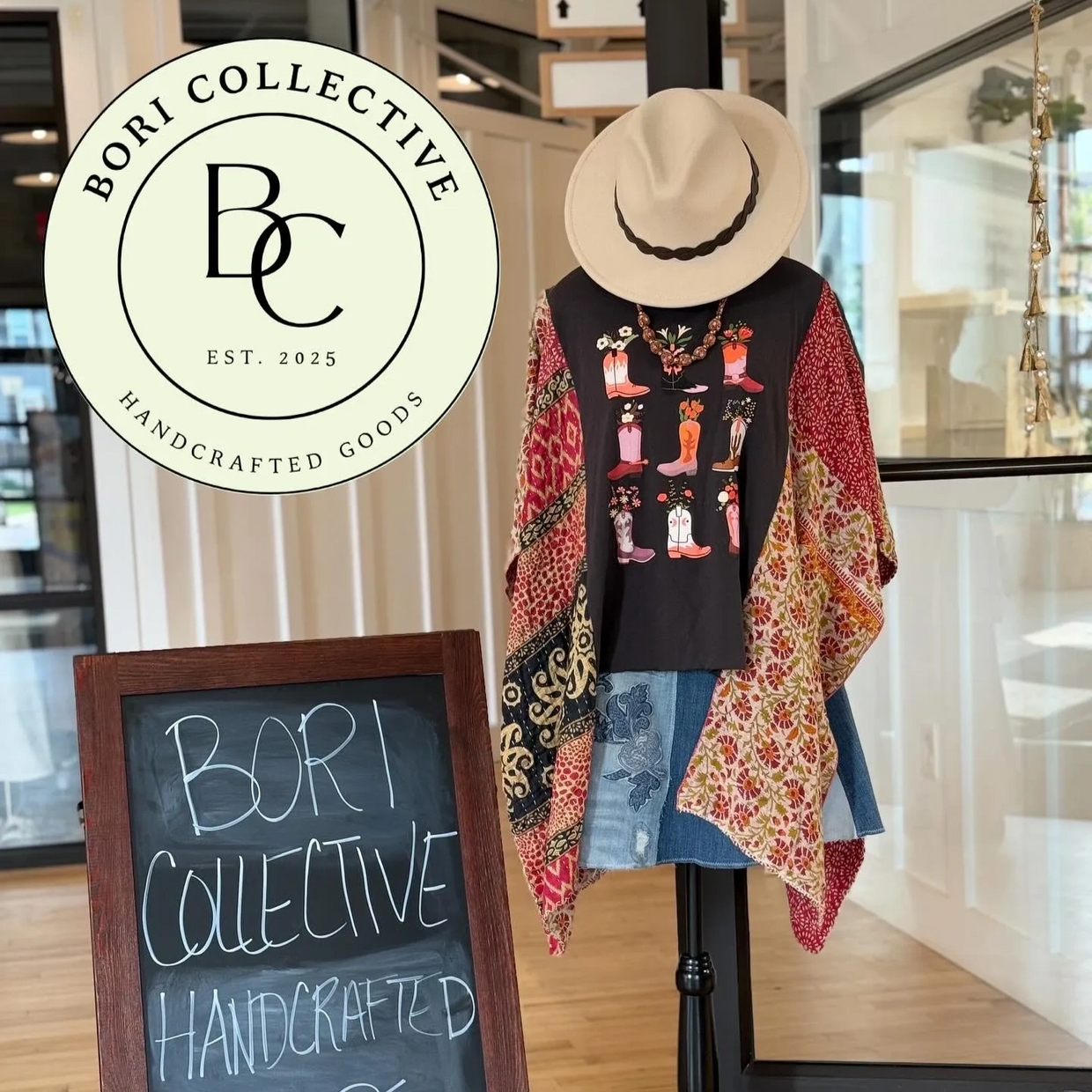 Entrance to store with board sign, Bori Collective logo and mannequin with a festival top and hat
