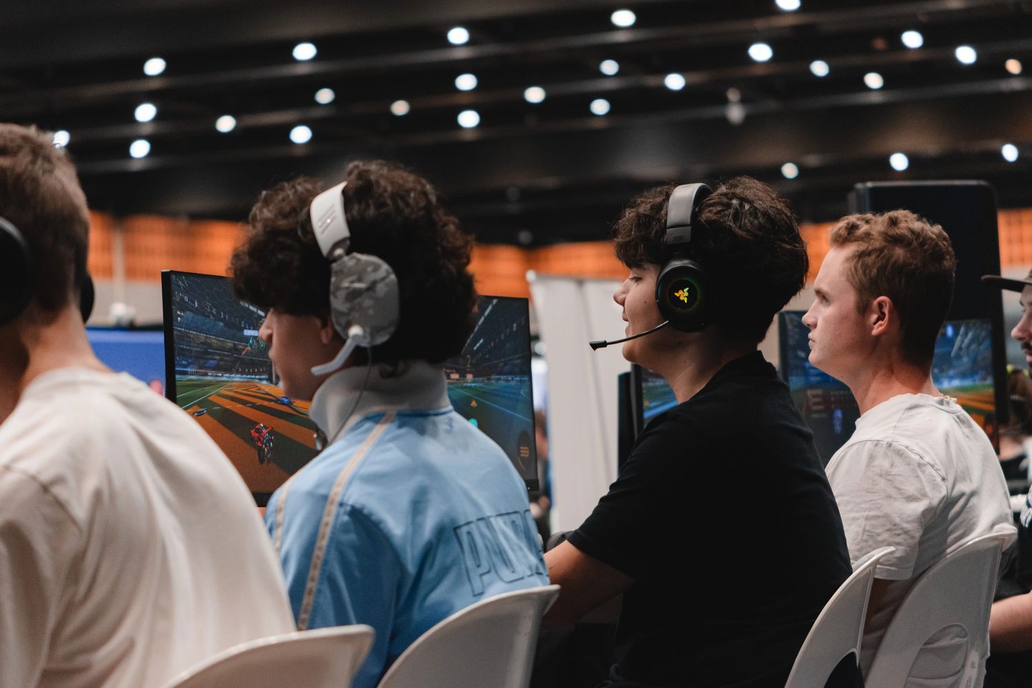 Young gamers playing Rocket League in a competitive gaming setup.