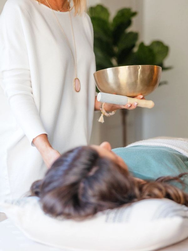 Gina Kitzmiller, Founder of Trimatri Reiki with a client.