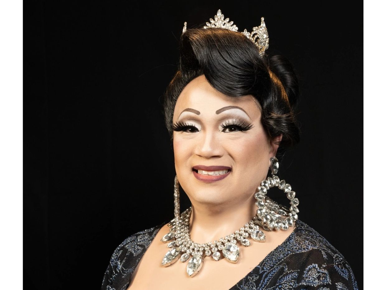 Portrait of a person with glamorous makeup and jeweled accessories.