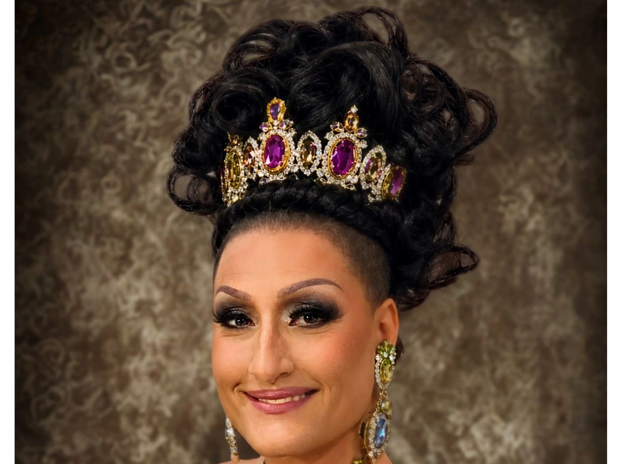 Person wearing a jeweled crown with styled hair.