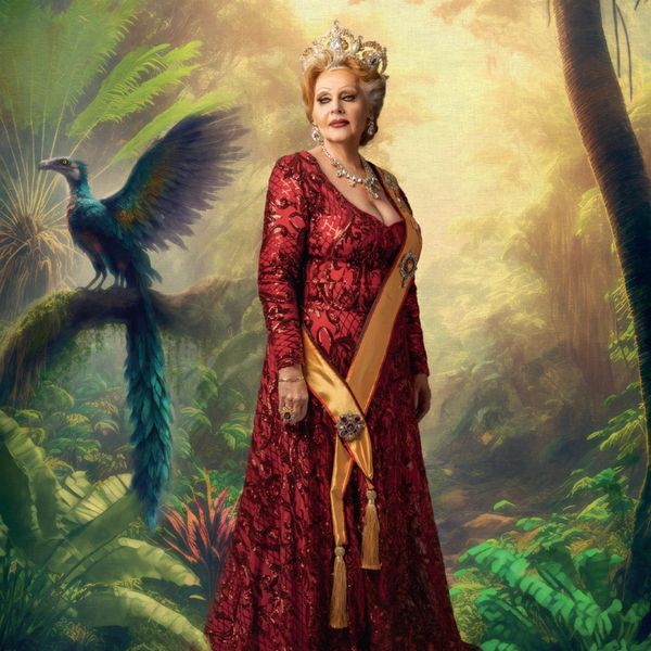 A regal woman in a red gown and crown stands in a mystical jungle with a colorful bird beside her.
