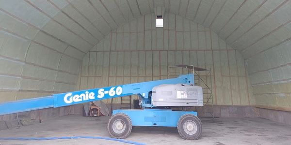 Blue Genie S-60 lift inside a large insulated warehouse.