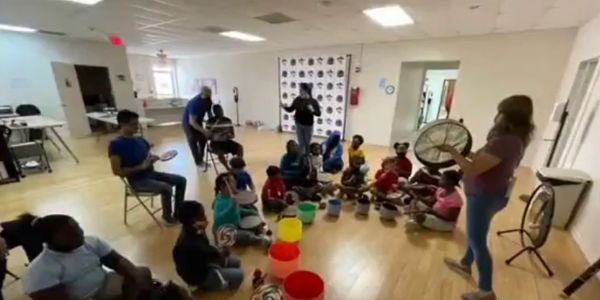 Zee Delgado at a special needs school with instruments; playing for the kids!