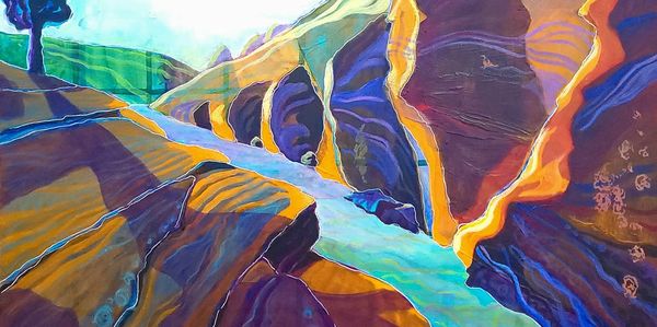 Artist’s vibrant painting of rocky canyon formation featuring saturated colors + dynamic brushwork.
