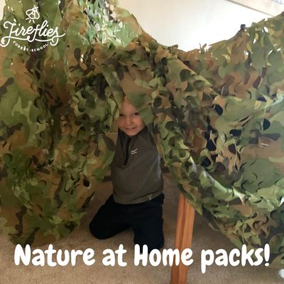 Child playing under a camo net tent indoors.