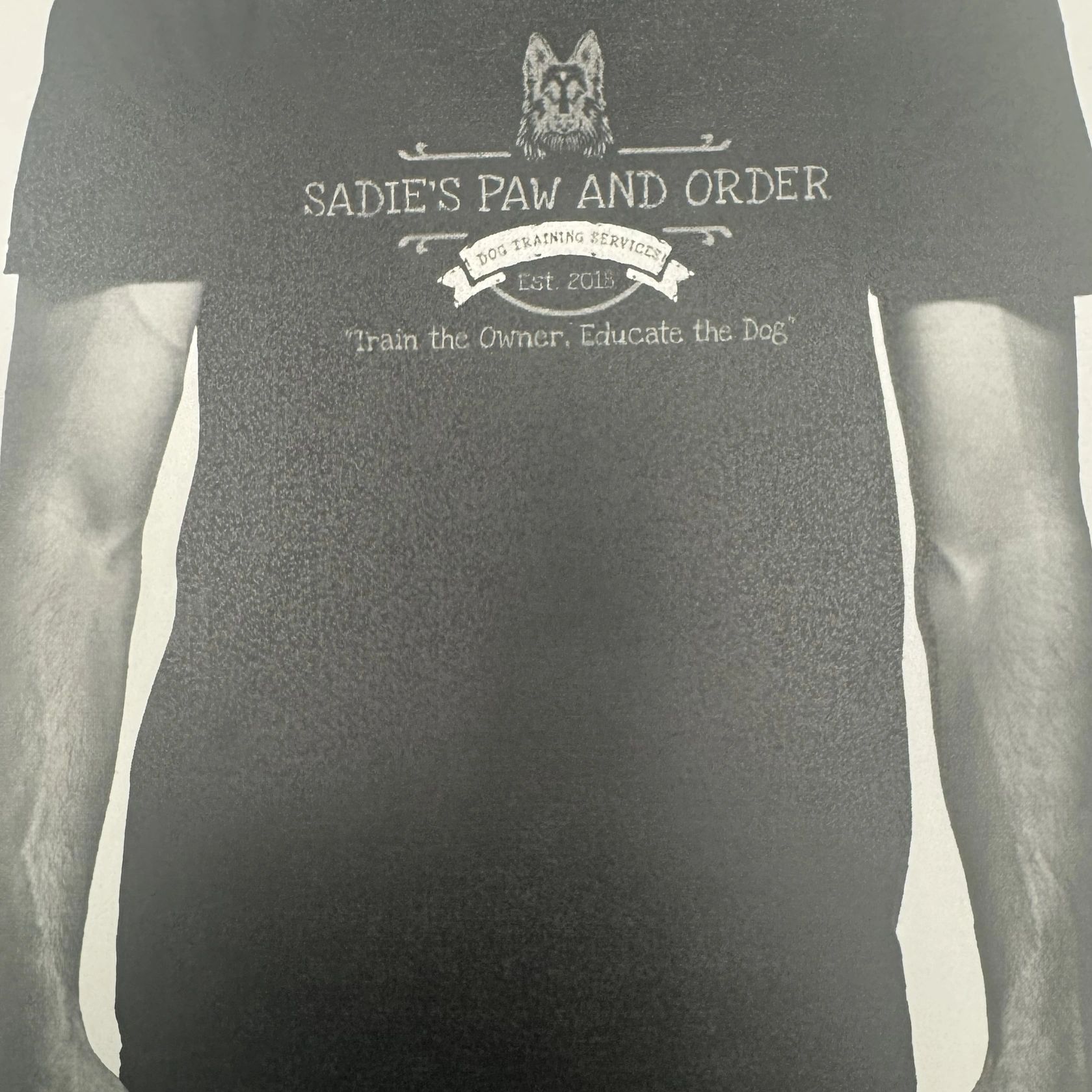 T-shirt with Sadie's Paw and Order dog training logo.