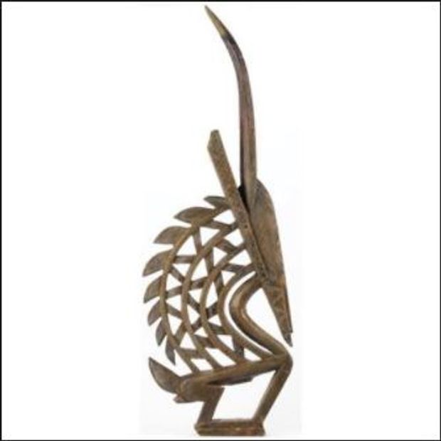 Intricately carved wooden African tribal mask with geometric patterns.