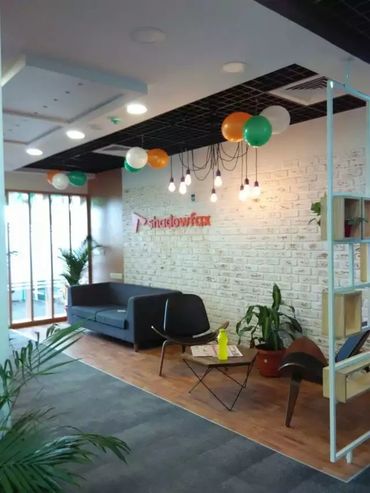 Spacious breakout zone featuring modern decor and comfortable seating arrangements.
