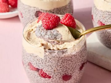 Chia seed pudding with raspberries in a glass jar.