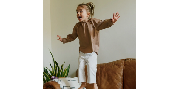 kid with a lot of energy jumping on the couch