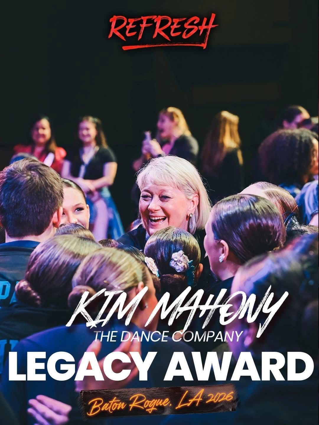 Kim Mahony receiving the Legacy Award with a joyful group around her.