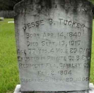 Gravestone of Jesse B. Tucker with birth and death dates, and military details.