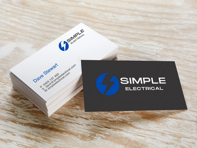 Digital Printed business card on wood grain background.  Simple Electrical Logo.