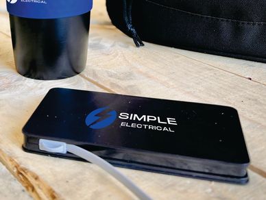 simple electrical. black wireless charging powerbank with two colour pad print. power bank. tradie.
