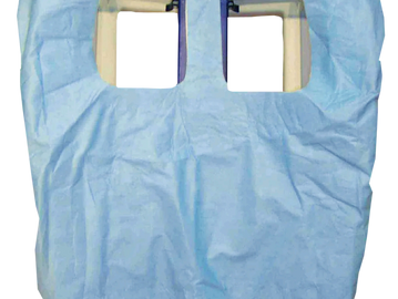 Light blue disposable apron with shoulder and arm openings.