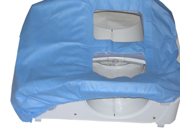 Blue fabric draped over a white device with two rectangular openings.