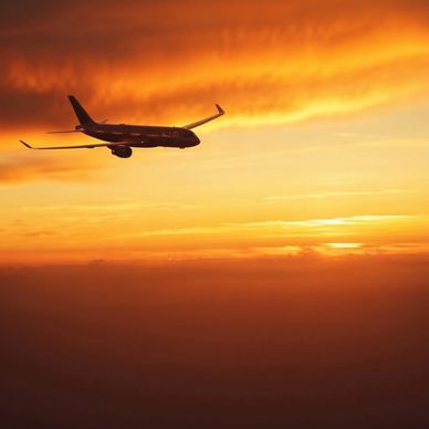 Airplane flying during a vibrant sunset.