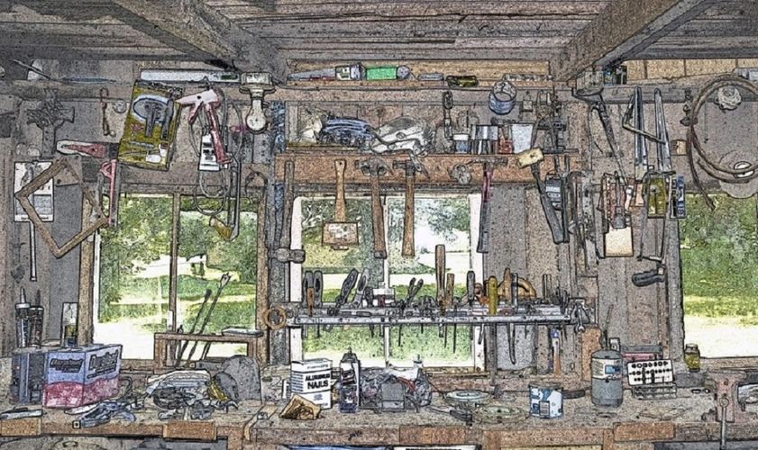 Stack of books next to pencils in a holder and a camera.