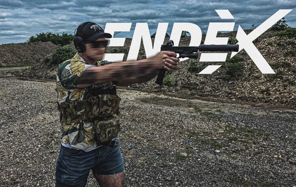 Person aiming a gun at an outdoor shooting range with 'ENDEX' text overlay.