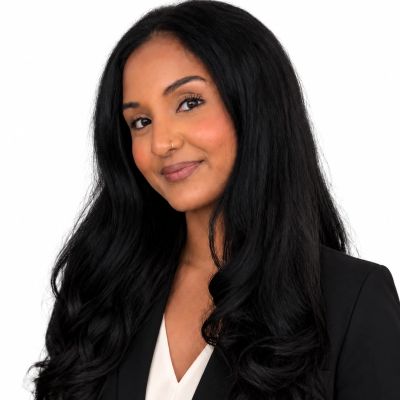 Professional woman with long black hair and a confident smile.