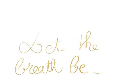 Elegant handwritten phrase 'Let the breath be' in gold ink on white.