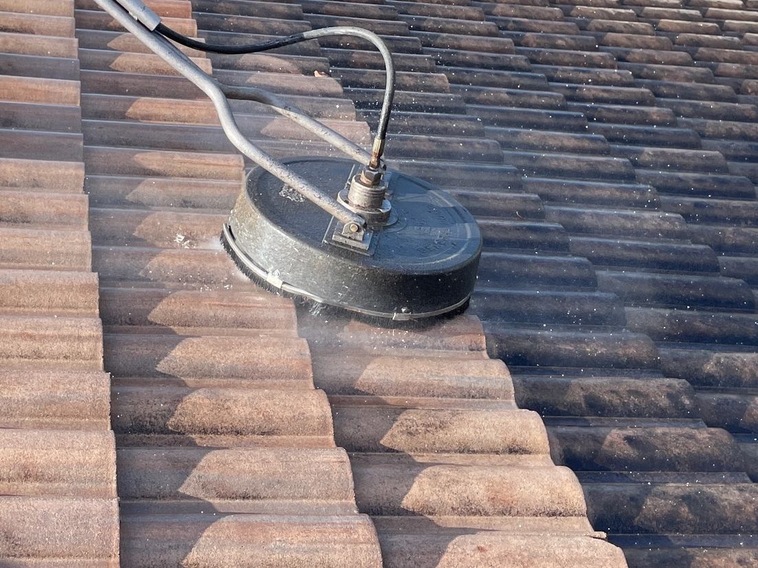 Tile roof being power washed 
