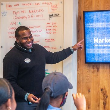 Man giving a presentation to a group in a casual setting.
