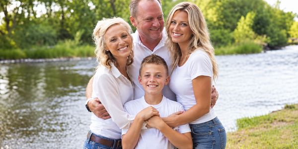 Happy family posing outdoors by the river.