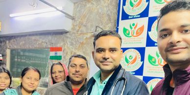 Group of healthcare workers posing together in a clinic setting.