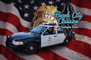 Police car with American flag and Beach City Classics logo in Huntington Beach.