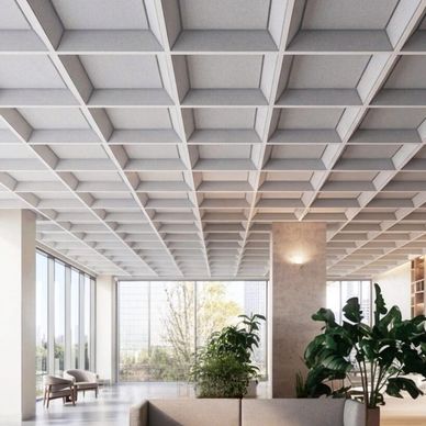 Modern interior with grid ceiling and large windows.