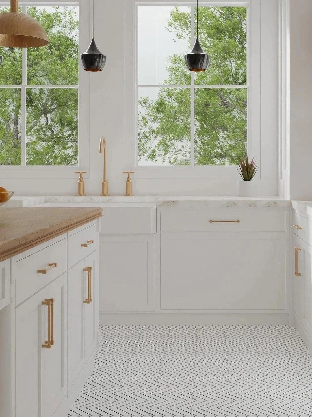Bright kitchen with white cabinetry, gold fixtures, and patterned tile floor.
