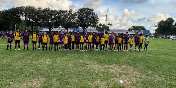 Players at soccer training camp. Boys enjoy a football match vs UK Team.