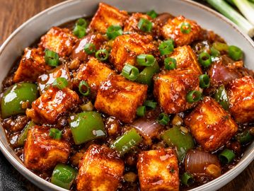 Spicy paneer cubes cooked with green peppers and onions in a savory sauce.