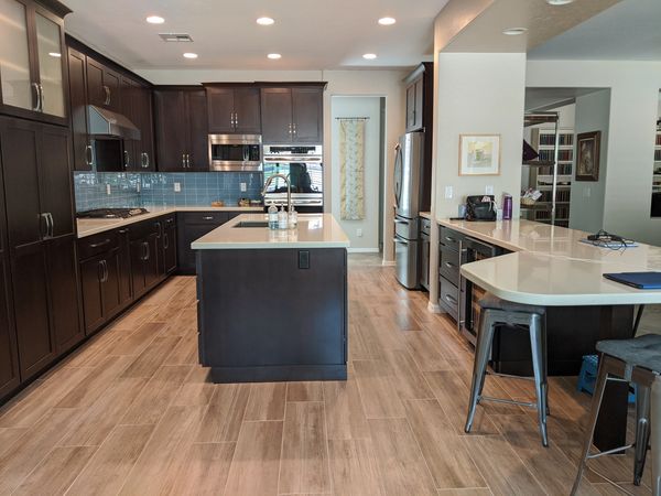 Crown Cabinets: Pioneer door in Alder wood in  Dark Chocolate stain.
Pental  quartz in Taj Mahal.