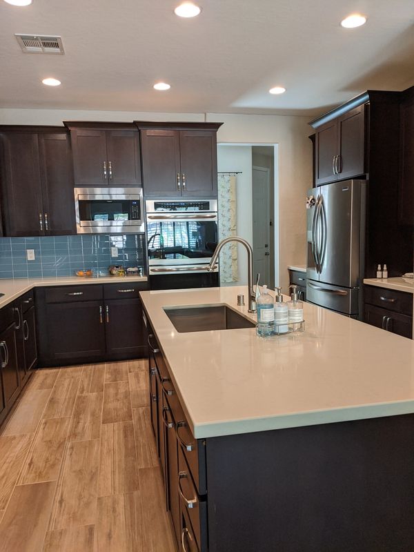 Crown Cabinets: Pioneer door in Alder wood in  Dark Chocolate stain.
Pental  quartz in Taj Mahal.