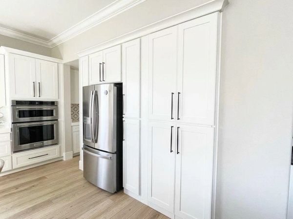 Crown Cabinets: Capri door in Maple wood w/ Designer White paint .