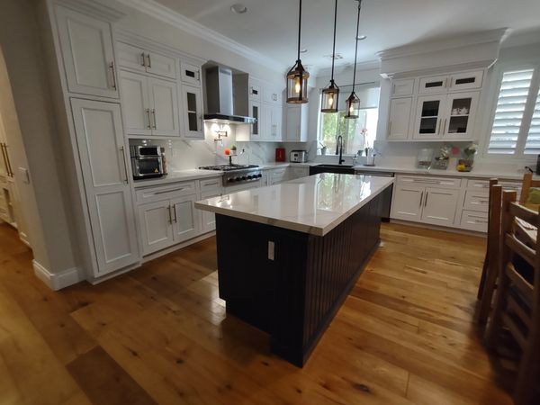 DeWils Cabinets: Avalon door with beaded frame in Just White paint for perimeter and Indigo Blue for