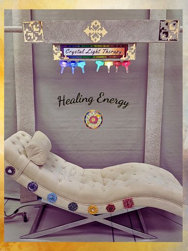 crystal light therapy bed with seven charka symbols and colored lights