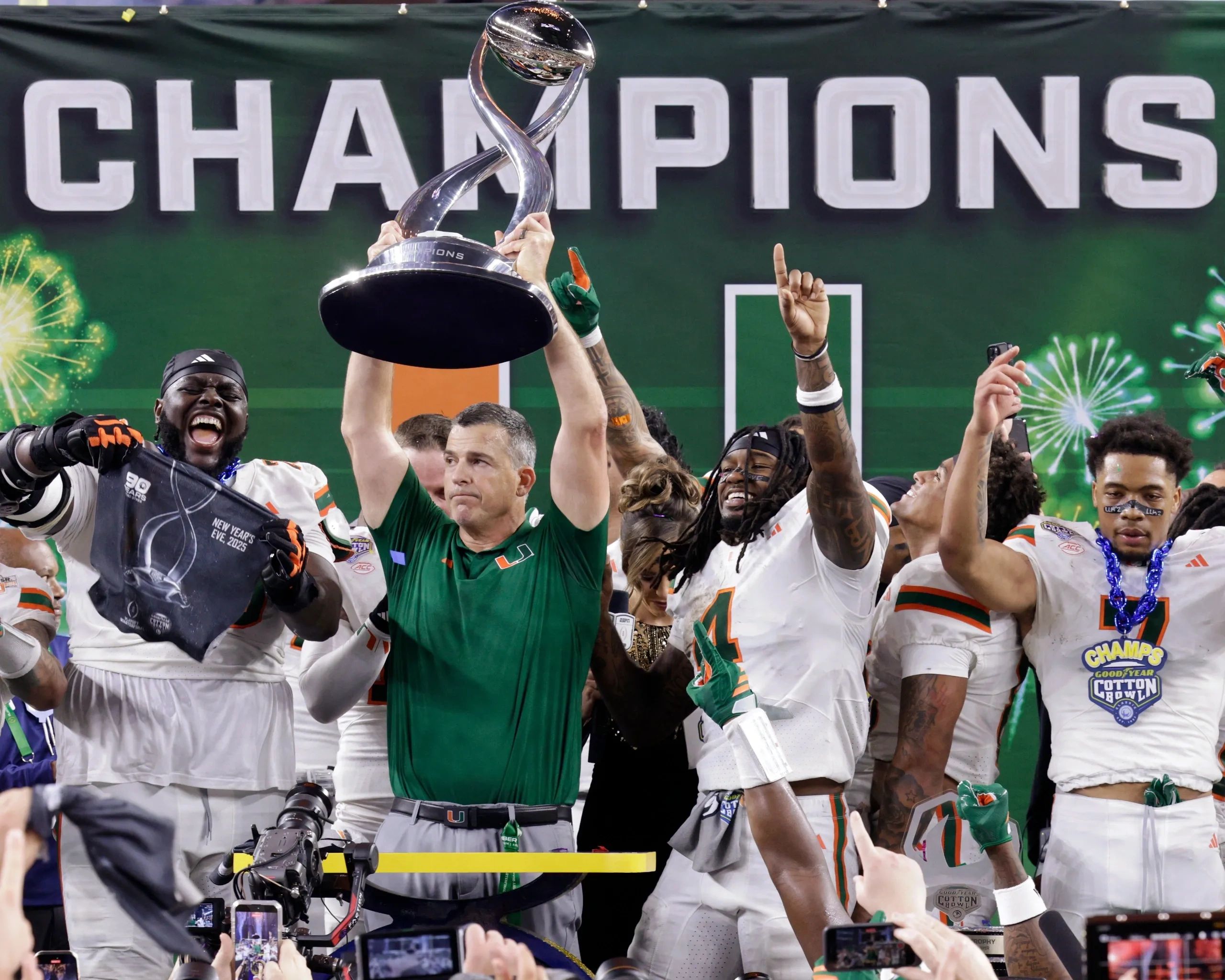 Football team celebrates winning the championship with trophy and excitement.