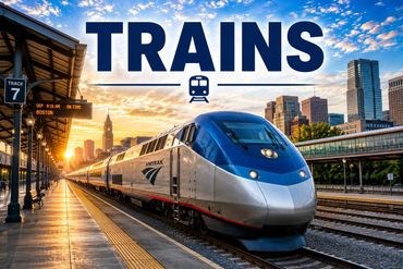 Modern Amtrak train at sunset in a city station.